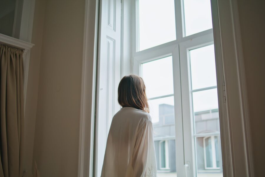 persona che guarda dalla finestra
